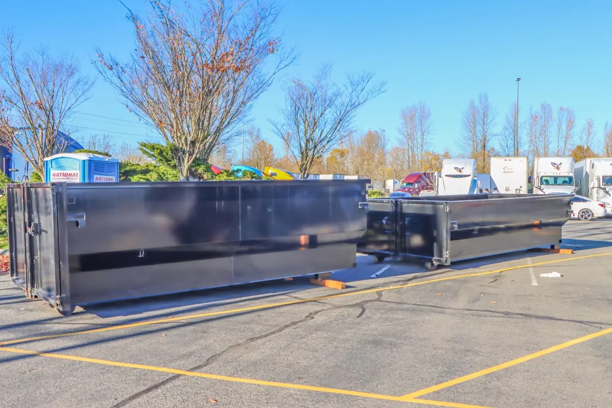 Professional dumpster rental service with roll-off container on residential driveway in Black Mountain